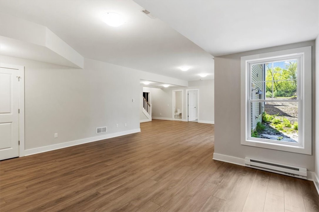 57 Coventry Ridge Pittsford, NY 14534 - Photo 31 of 37 Finished terrace level with LVP flooring in rec ro