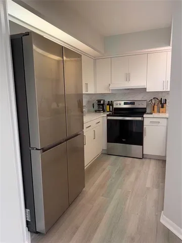 a kitchen with a refrigerator sink and stove