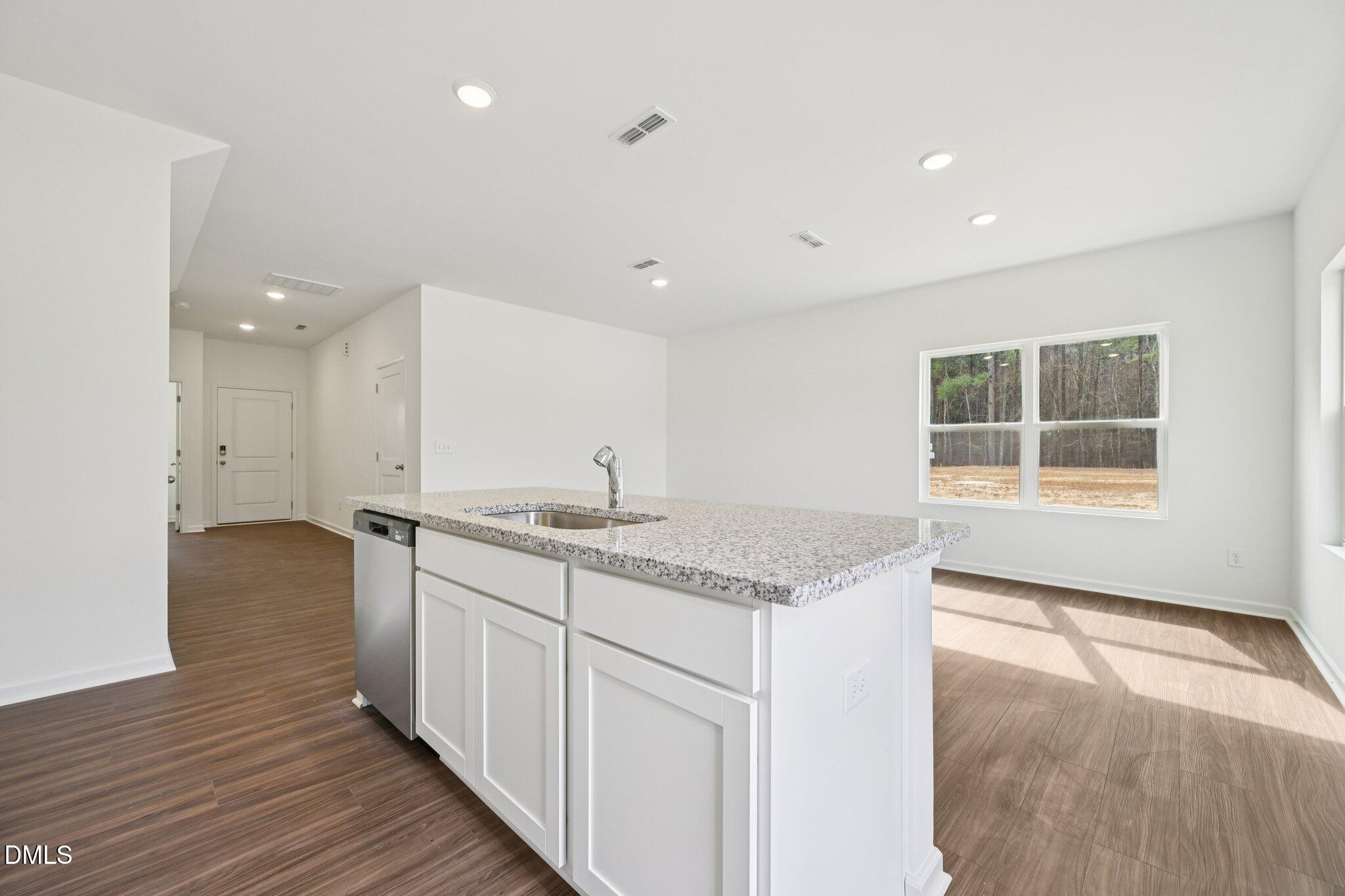 1610 Mirth Court Rolesville, NC 27571 - Photo 16 of 36 a kitchen with a sink stove and cabinets