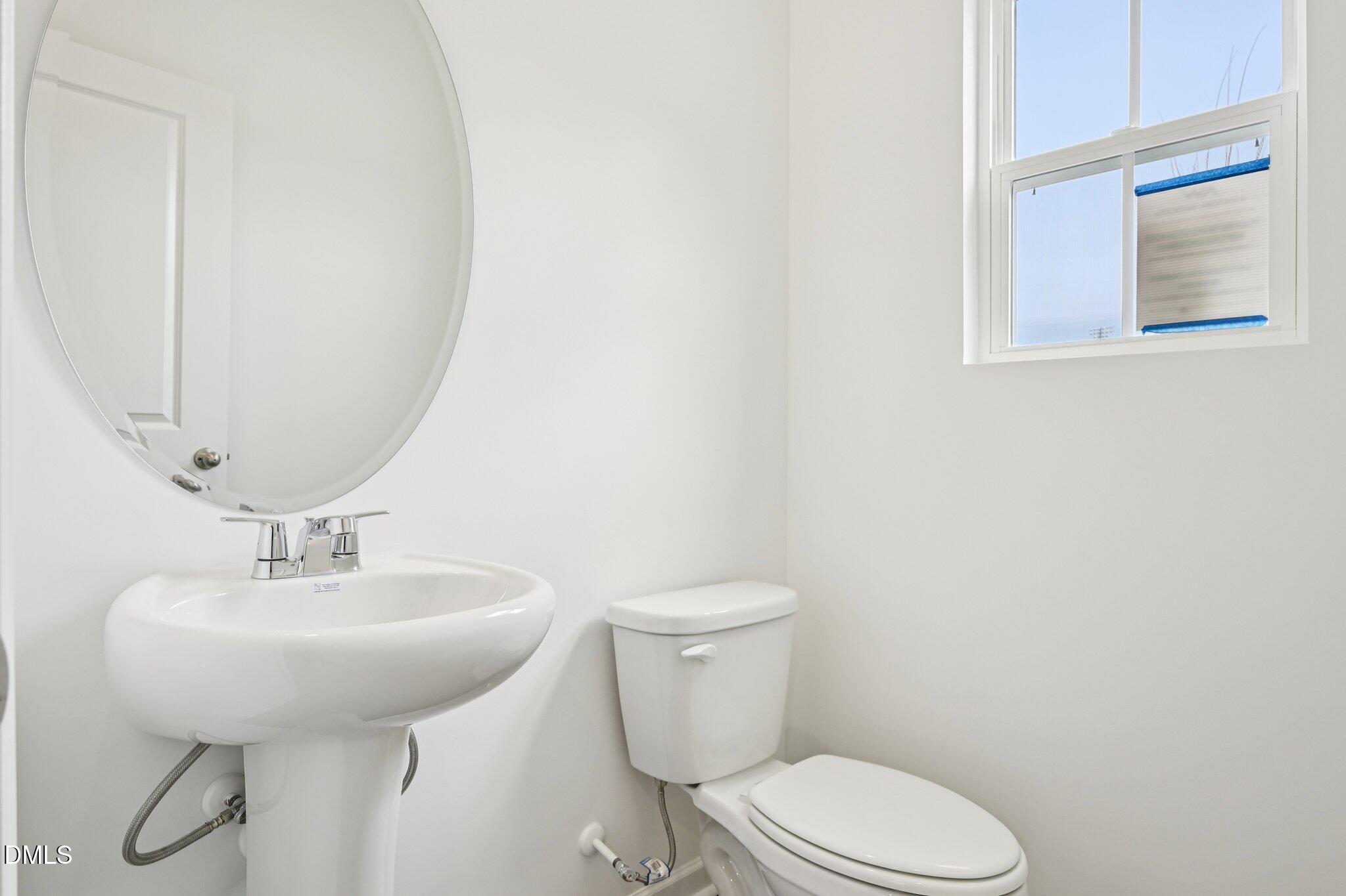 1610 Mirth Court Rolesville, NC 27571 - Photo 18 of 36 a bathroom with a toilet sink and mirror