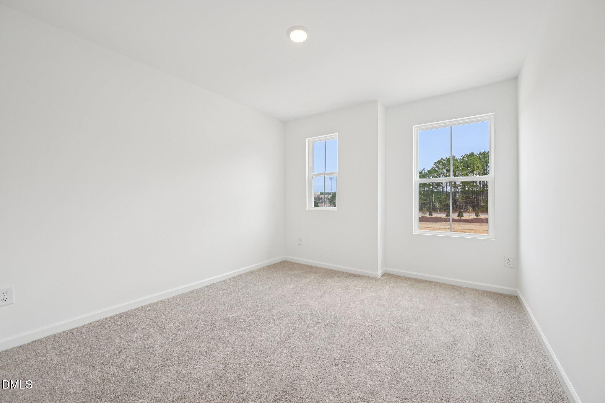 1610 Mirth Court Rolesville, NC 27571 - Photo 19 of 36 an empty room with windows