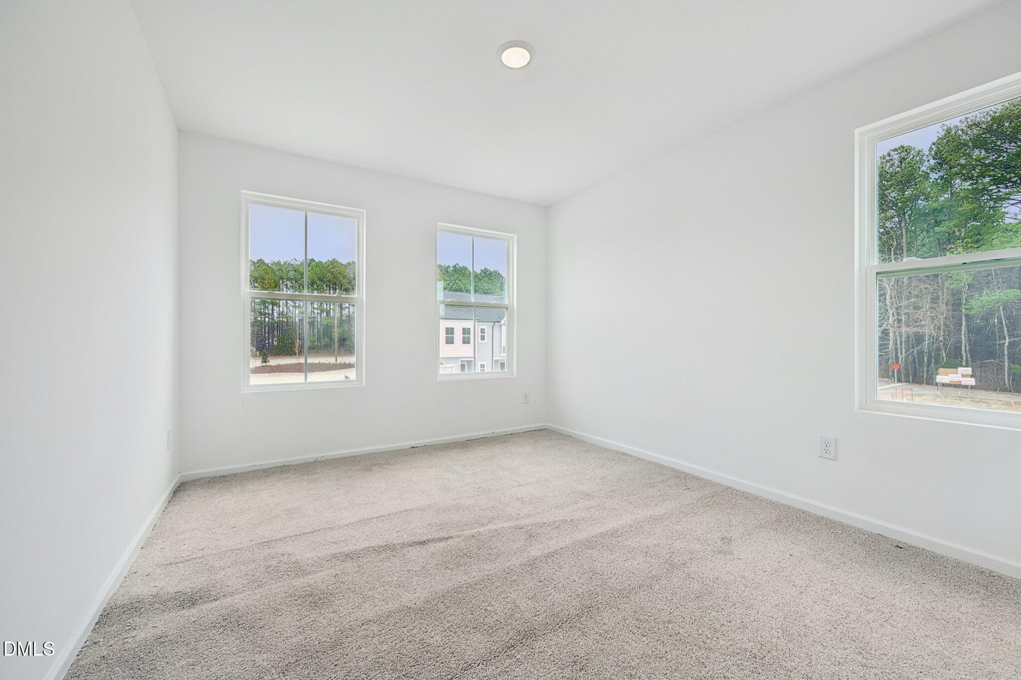 1610 Mirth Court Rolesville, NC 27571 - Photo 21 of 36 an empty room with windows