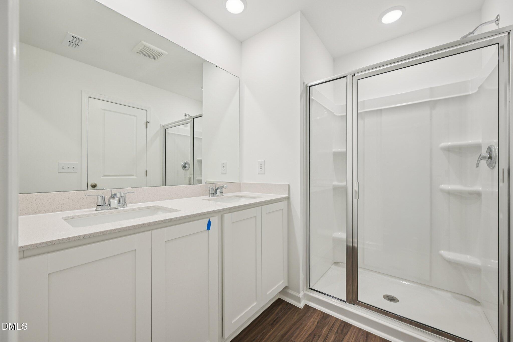 1610 Mirth Court Rolesville, NC 27571 - Photo 27 of 36 a bathroom with a double vanity sink mirror and shower