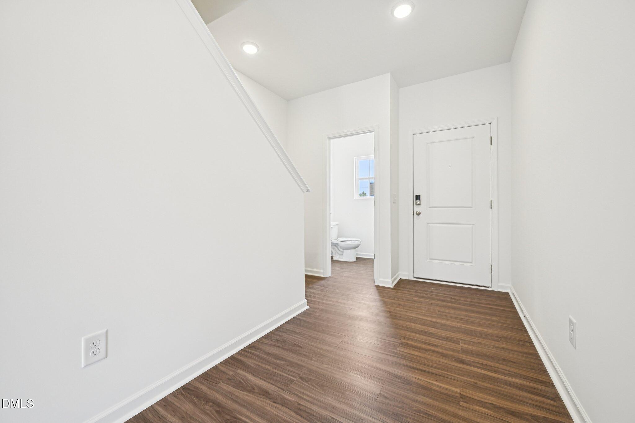 1610 Mirth Court Rolesville, NC 27571 - Photo 4 of 36 a view of a hallway with wooden floor