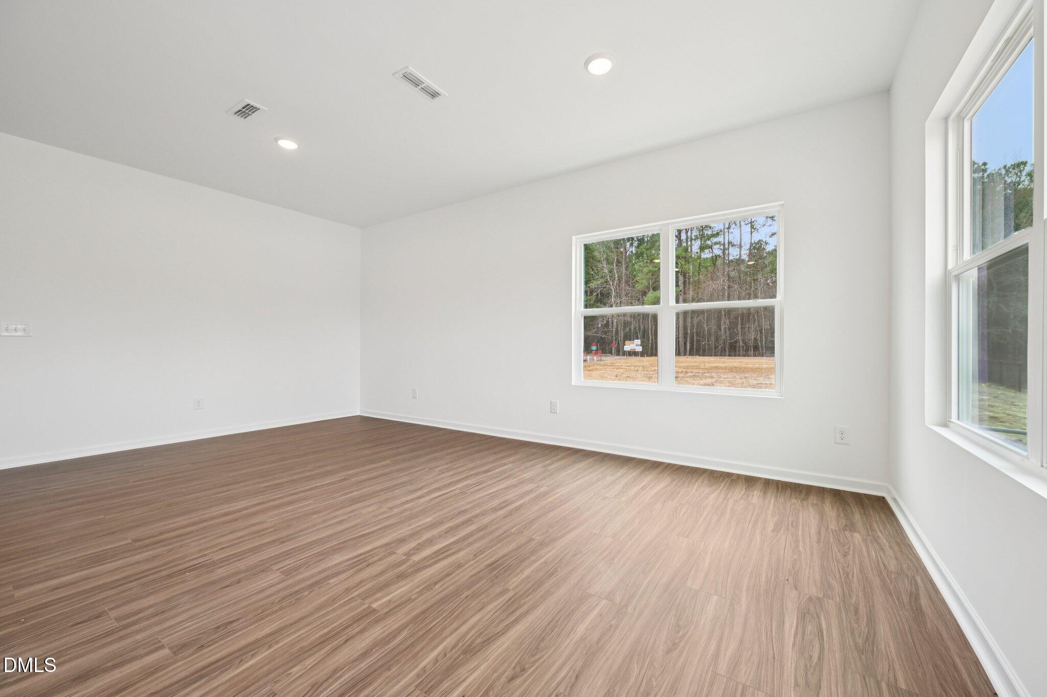 1610 Mirth Court Rolesville, NC 27571 - Photo 6 of 36 wooden floor in an empty room with a window