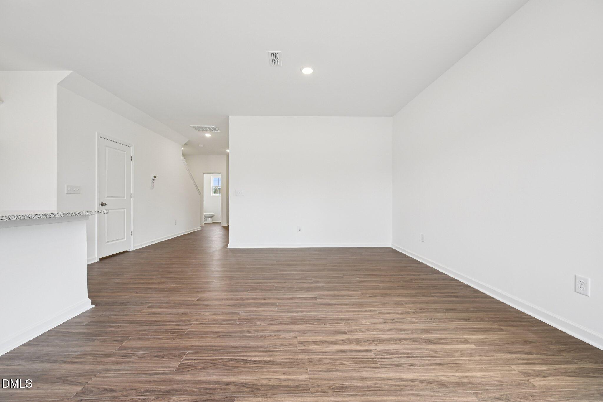 1610 Mirth Court Rolesville, NC 27571 - Photo 7 of 36 a view of an empty room with wooden floor