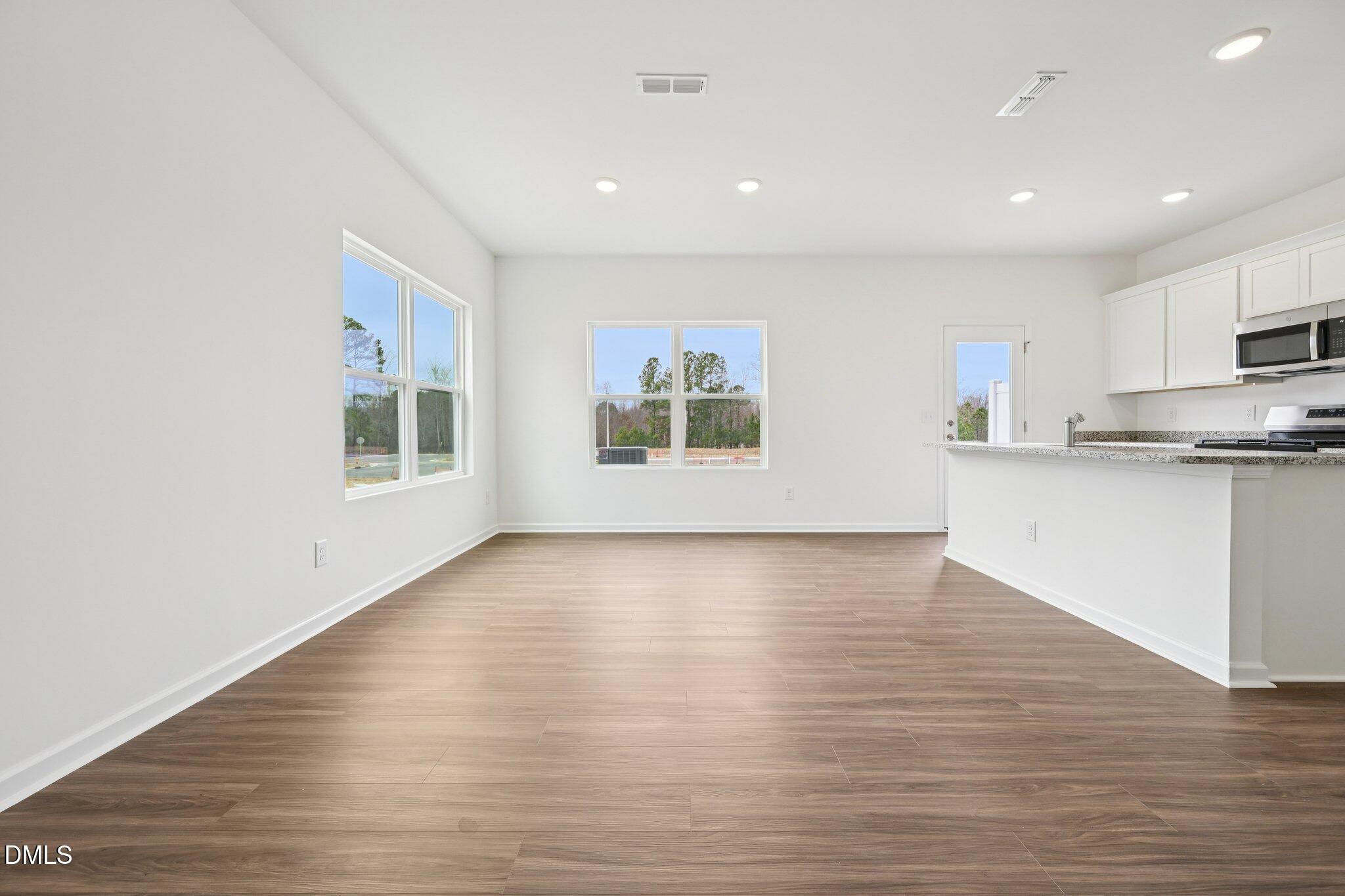 1610 Mirth Court Rolesville, NC 27571 - Photo 8 of 36 a view of kitchen with wooden floor and electronic appliances