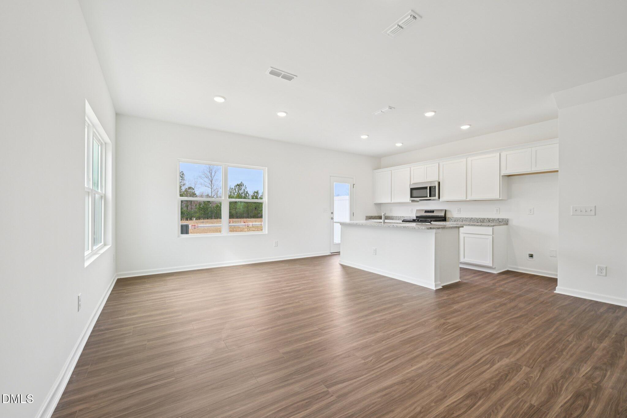 1610 Mirth Court Rolesville, NC 27571 - Photo 9 of 36 a view of kitchen with wooden floor and window