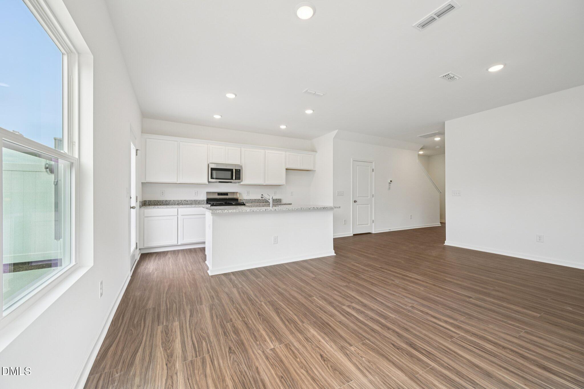 1610 Mirth Court Rolesville, NC 27571 - Photo 10 of 36 a view of kitchen with granite countertop cabinets and refrigerator