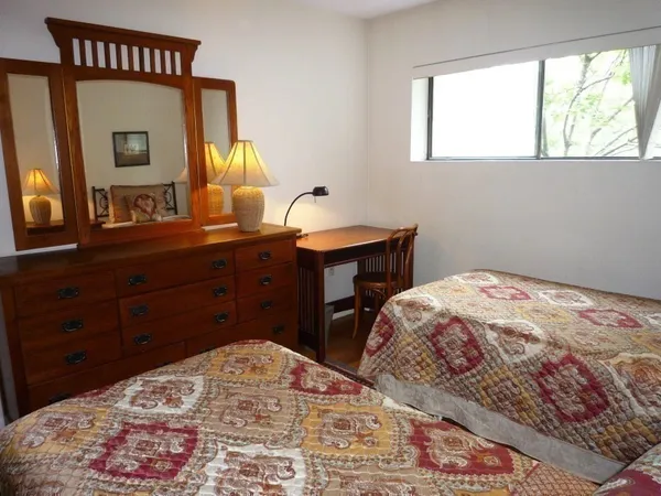 a bedroom with a bed and a dresser