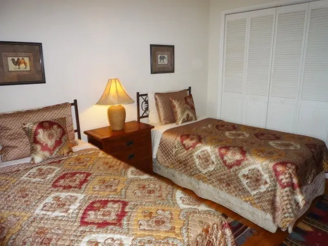 a bedroom with a bed and lamp