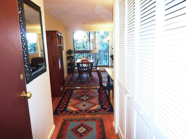 a dining room with furniture and a floor to ceiling window