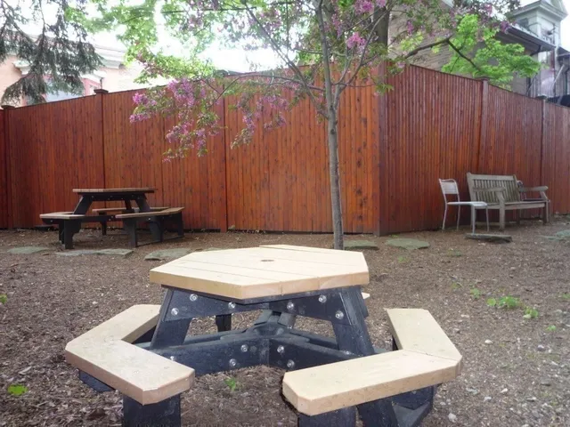 a backyard of a house with table and chairs