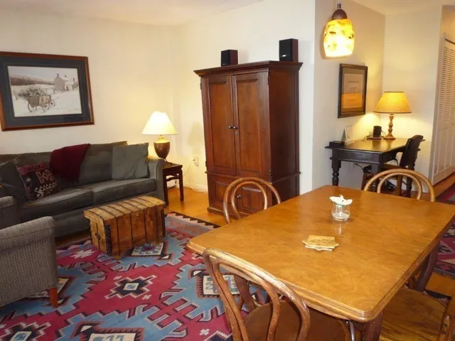 a view of a dining room with furniture and a window