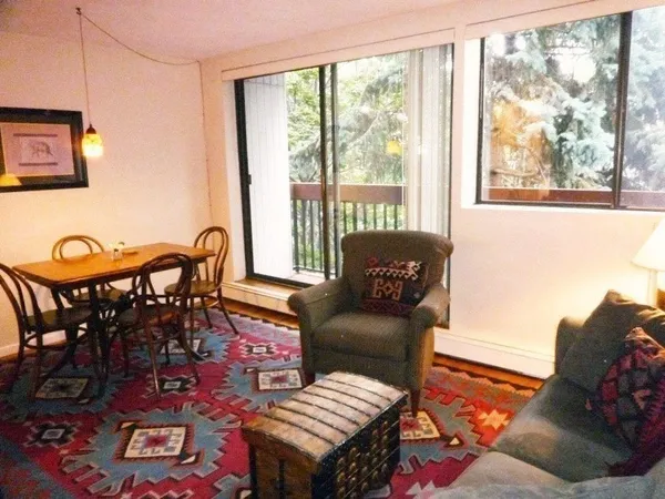 a living room with furniture and a floor to ceiling window