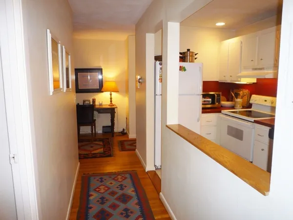 a kitchen with stainless steel appliances granite countertop a refrigerator and a stove