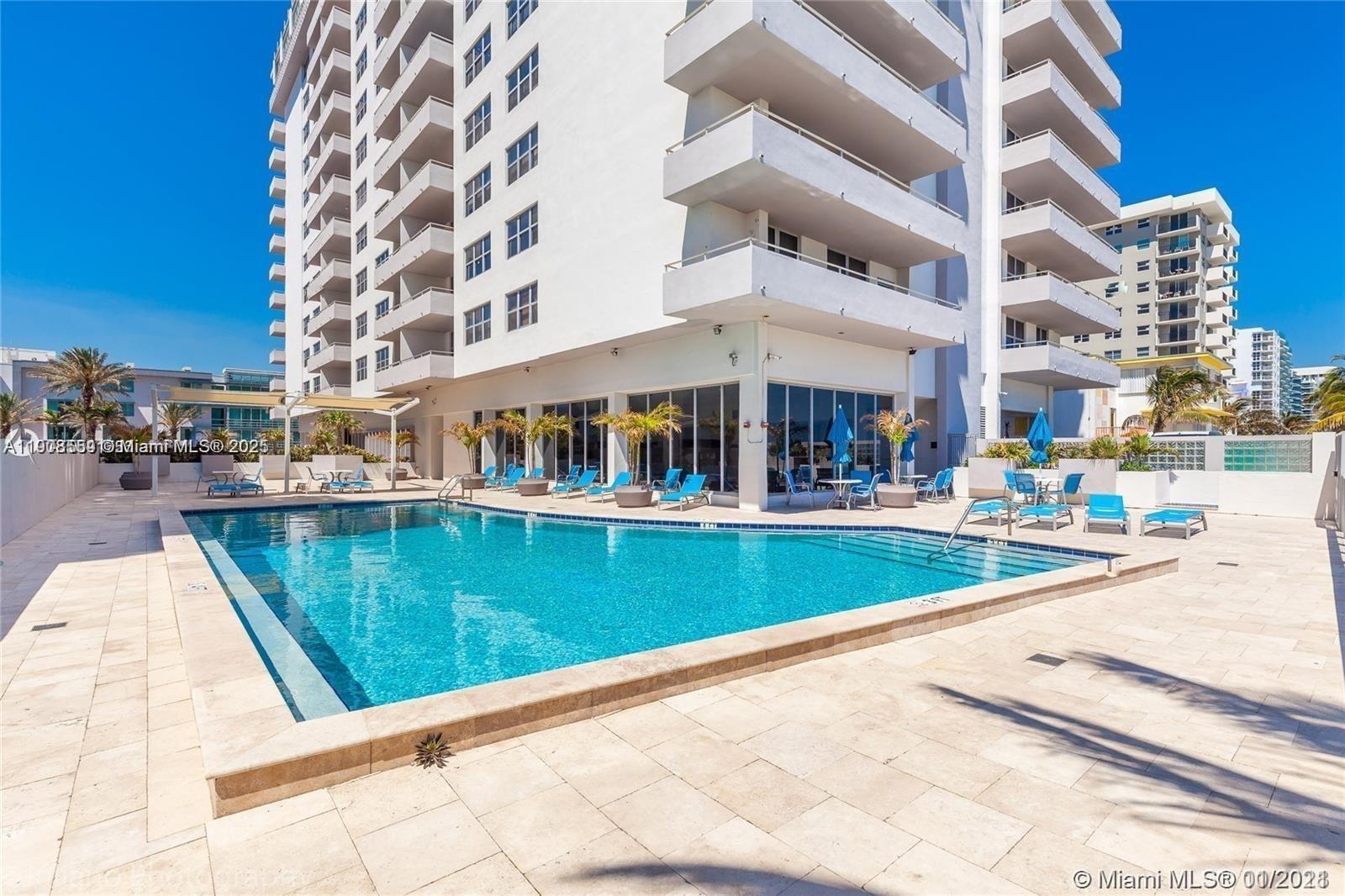 9225 Collins Avenue, Unit 1006 Surfside, FL 33154 - Photo 1 of 14 a view of swimming pool with building exterior