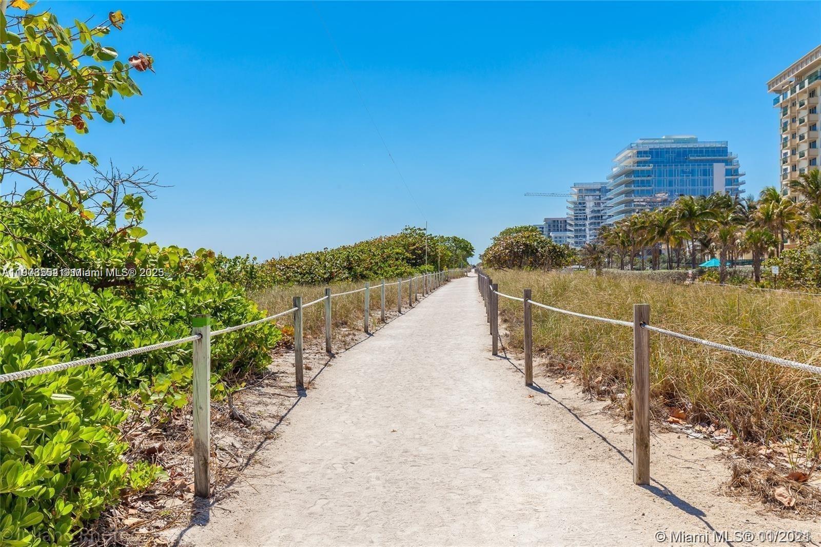 9225 Collins Avenue, Unit 1006 Surfside, FL 33154 - Photo 5 of 14 a view of a pathway with a building in the background