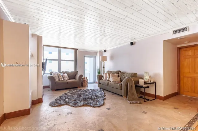 a living room with furniture ceiling fan and a window