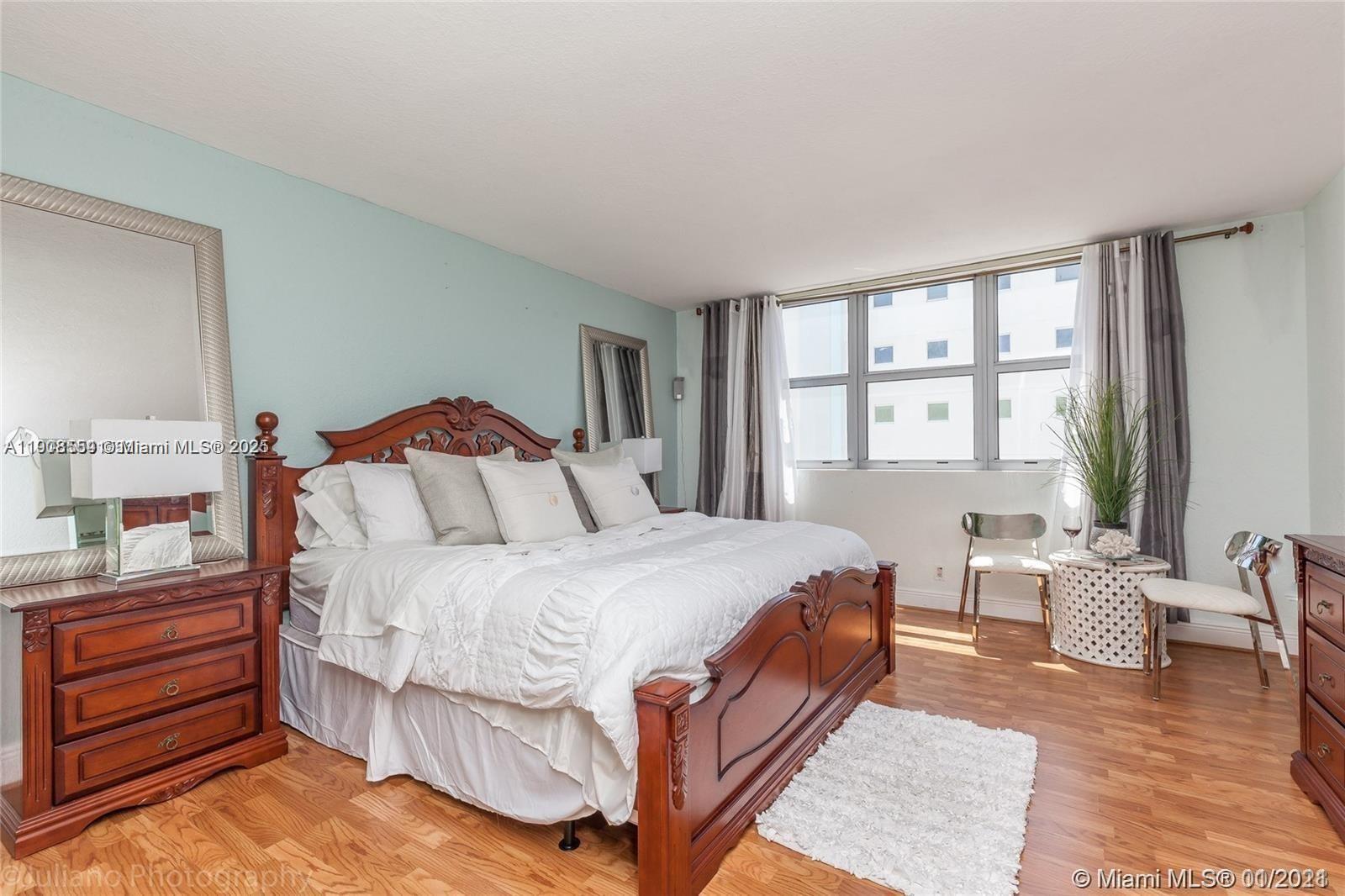 9225 Collins Avenue, Unit 1006 Surfside, FL 33154 - Photo 8 of 14 a bedroom with bed and windows