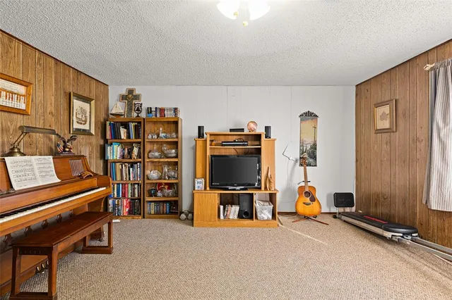 a view of a livingroom with furniture and a bookshelf