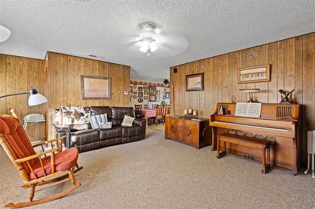 a kitchen with stainless steel appliances kitchen island granite countertop a sink a stove and refrigerator