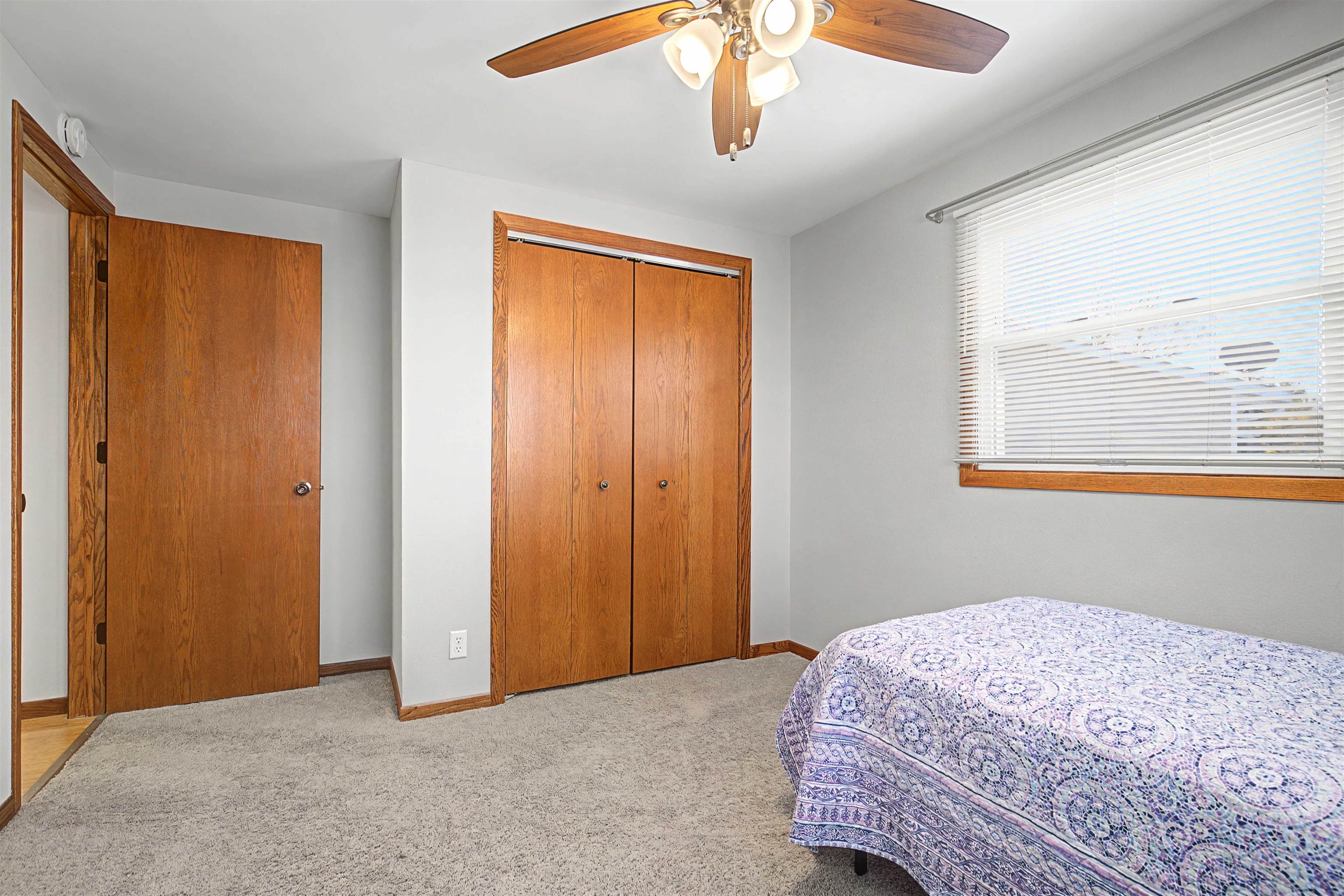 325 Apache Court Galena, IL 61036 - Photo 11 of 43 a bedroom with a bed and a chandelier