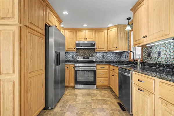 a view of an empty room with a kitchen
