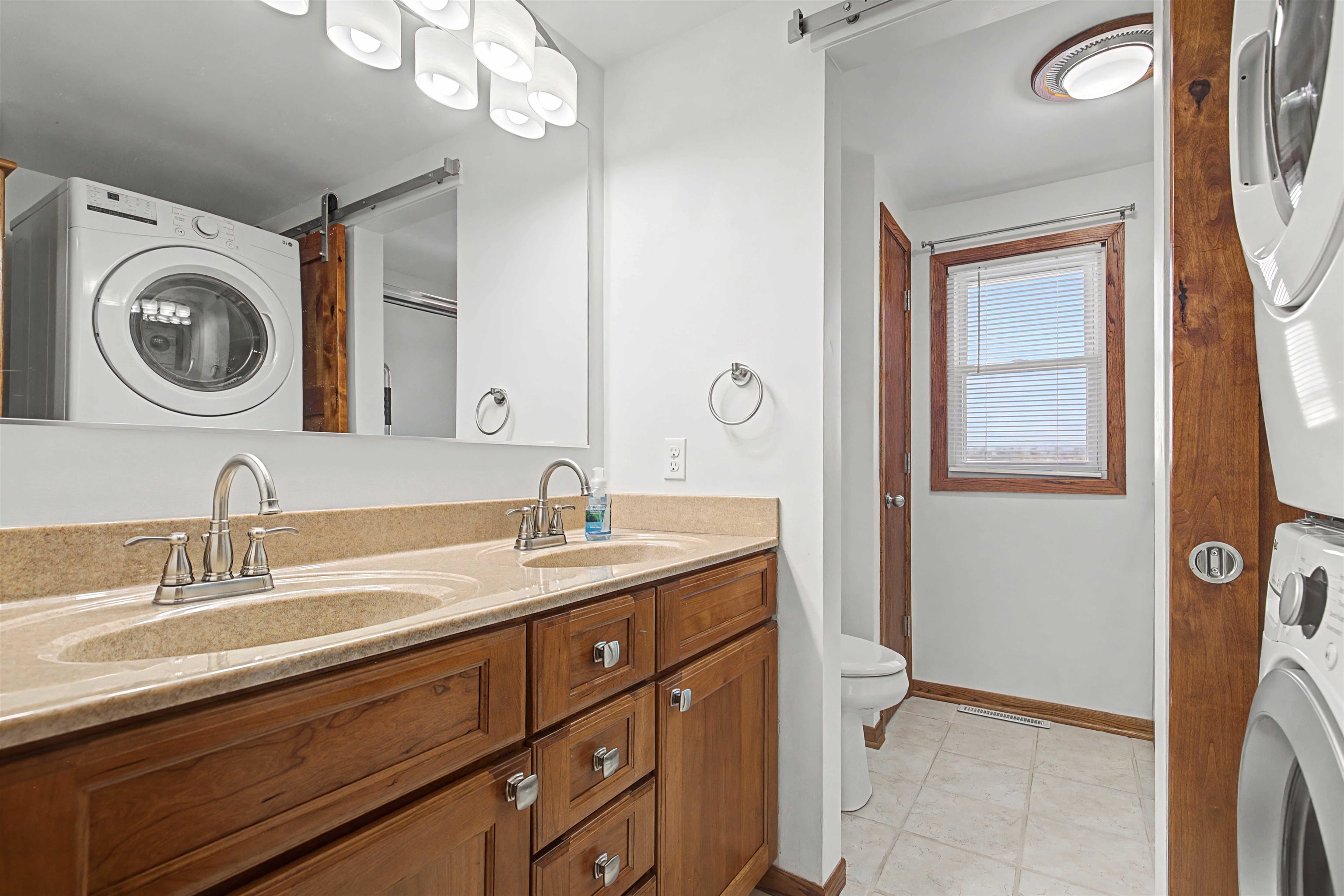 325 Apache Court Galena, IL 61036 - Photo 16 of 43 a bathroom with a toilet a sink and mirror