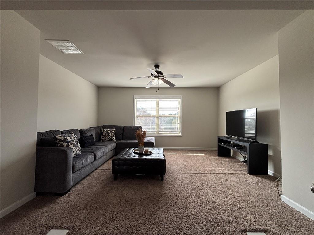 3459 In Bloom Way Auburn, GA 30011 - Photo 18 of 35 a living room with furniture and a flat screen tv