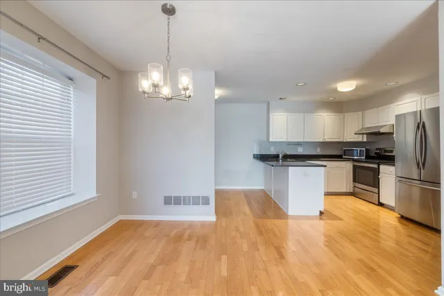 a view of empty room with a fireplace and a window