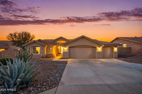 a front view of a house with yard and mountain view in back
