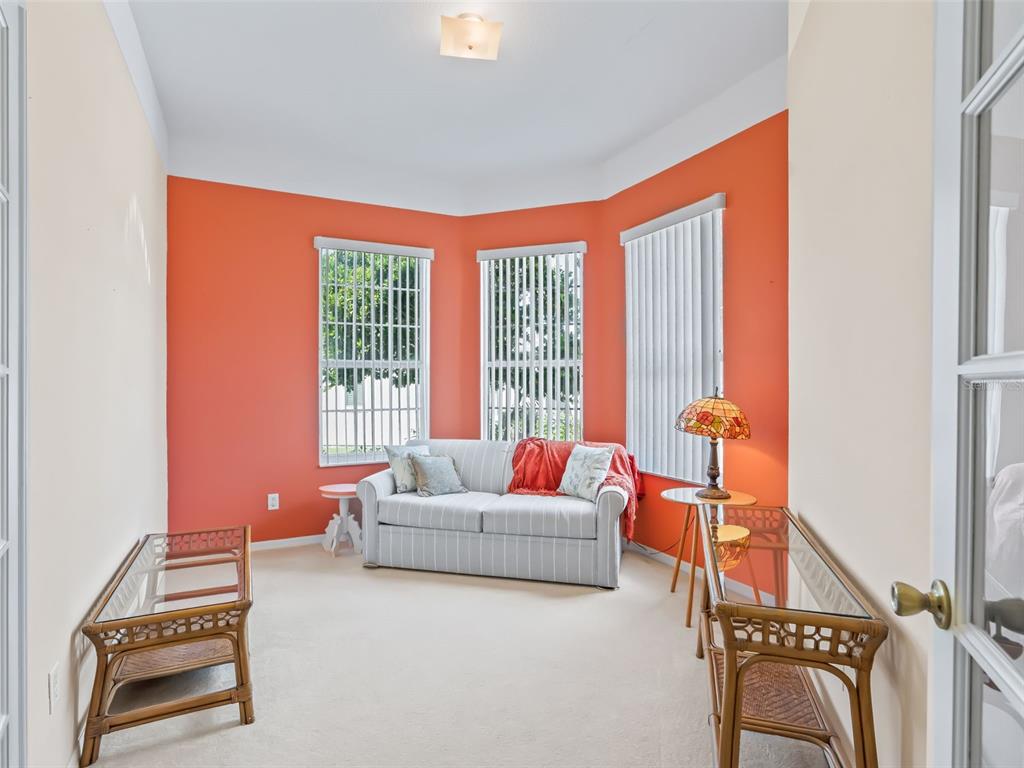 17786 Southeast 119th Avenue Road Summerfield, FL 34491 - Photo 28 of 43 a living room with furniture and a floor to ceiling window