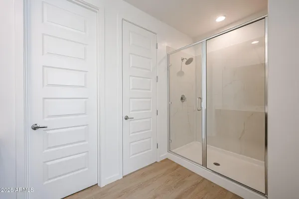 a bathroom with a shower and a glass door