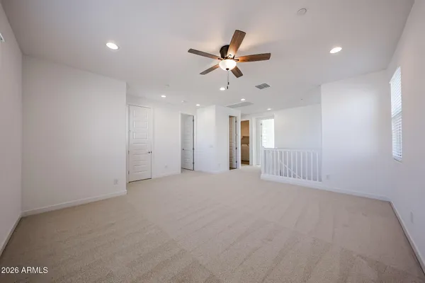 a view of an empty room with a ceiling fan