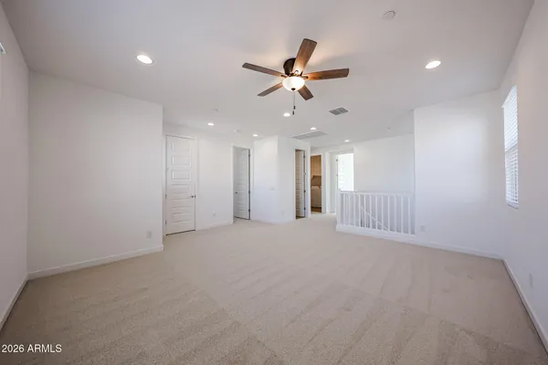 a view of an empty room with a ceiling fan