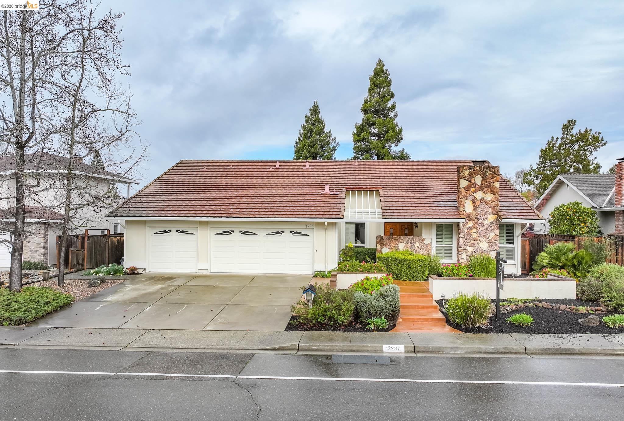 3237 Veracruz Drive San Ramon, CA 94583 - Photo 1 of 59 a front view of a house with a garden and plants
