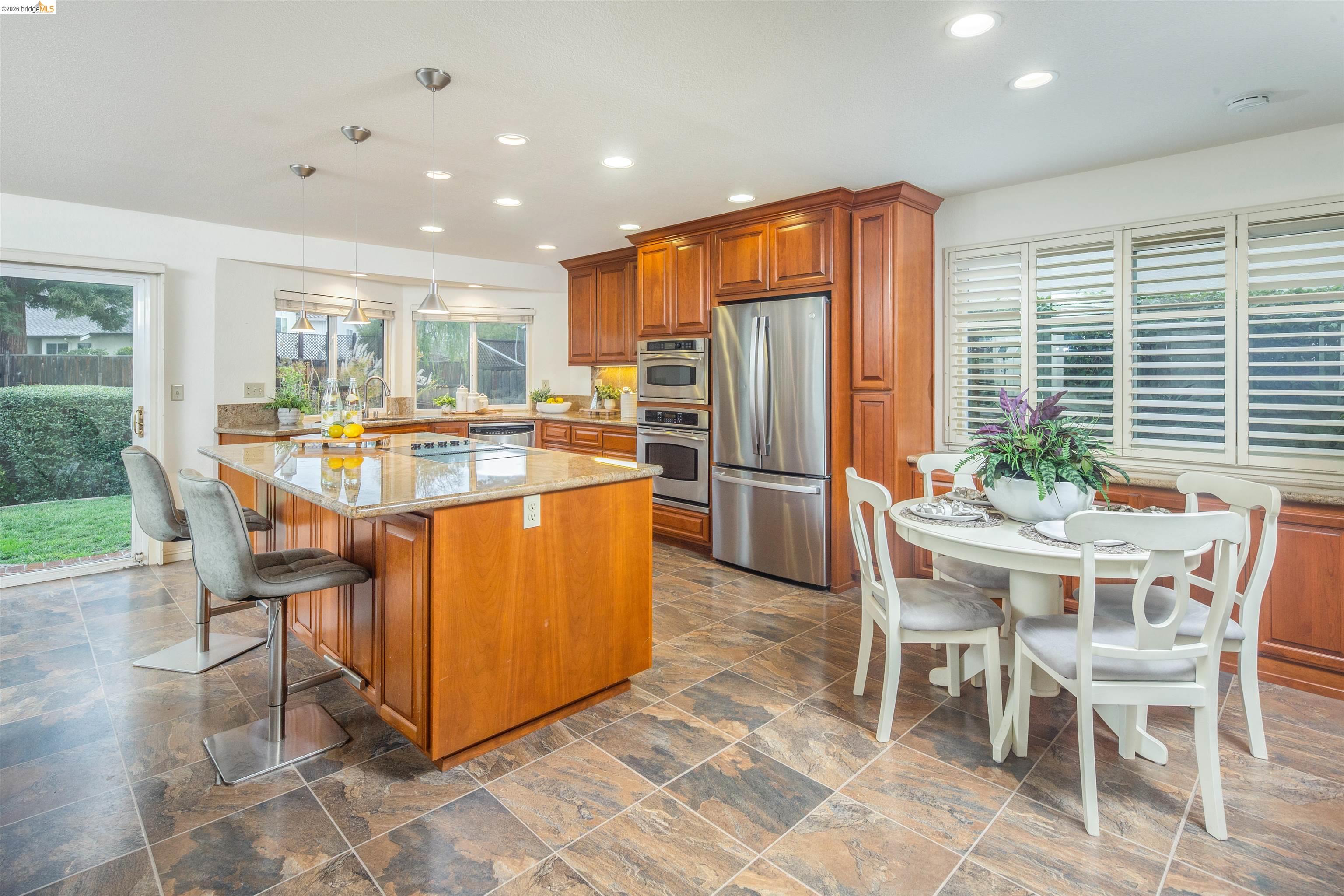 3237 Veracruz Drive San Ramon, CA 94583 - Photo 17 of 59 a dining table chairs and kitchen view with a large window