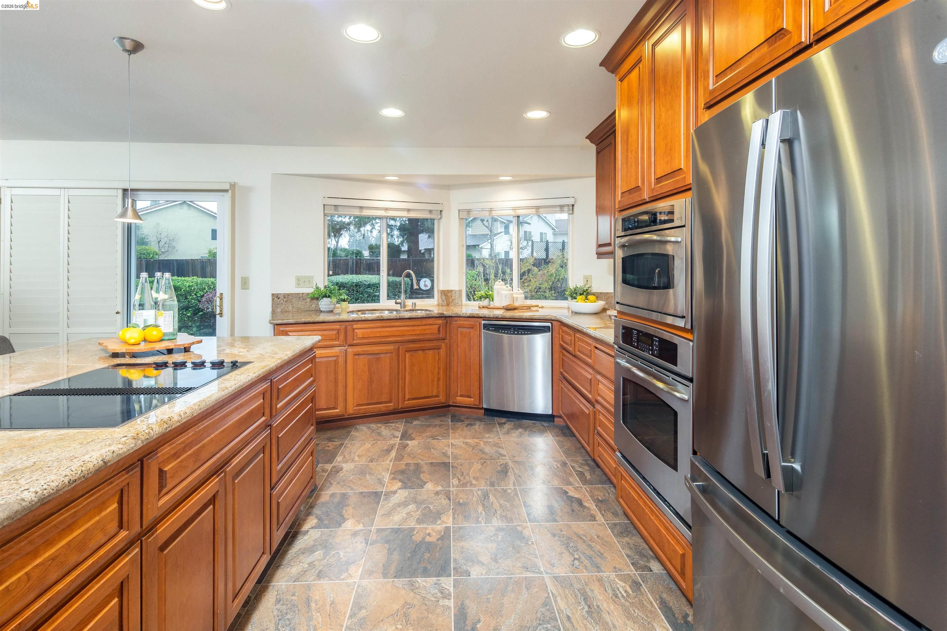 3237 Veracruz Drive San Ramon, CA 94583 - Photo 20 of 59 a large kitchen with stainless steel appliances granite countertop a large counter top a stove and a refrigerator