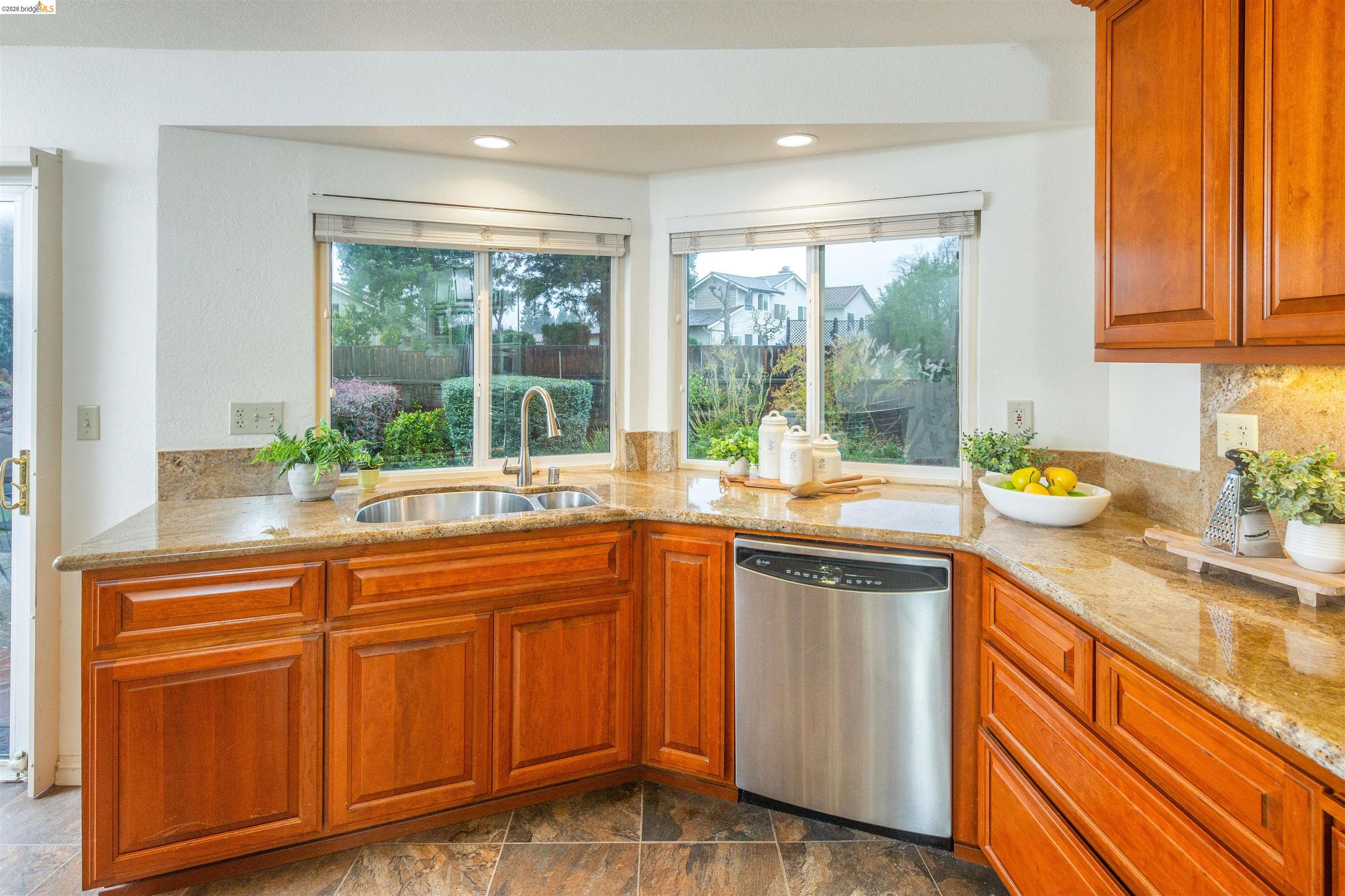 3237 Veracruz Drive San Ramon, CA 94583 - Photo 21 of 59 a kitchen with stainless steel appliances granite countertop white cabinets and a large window