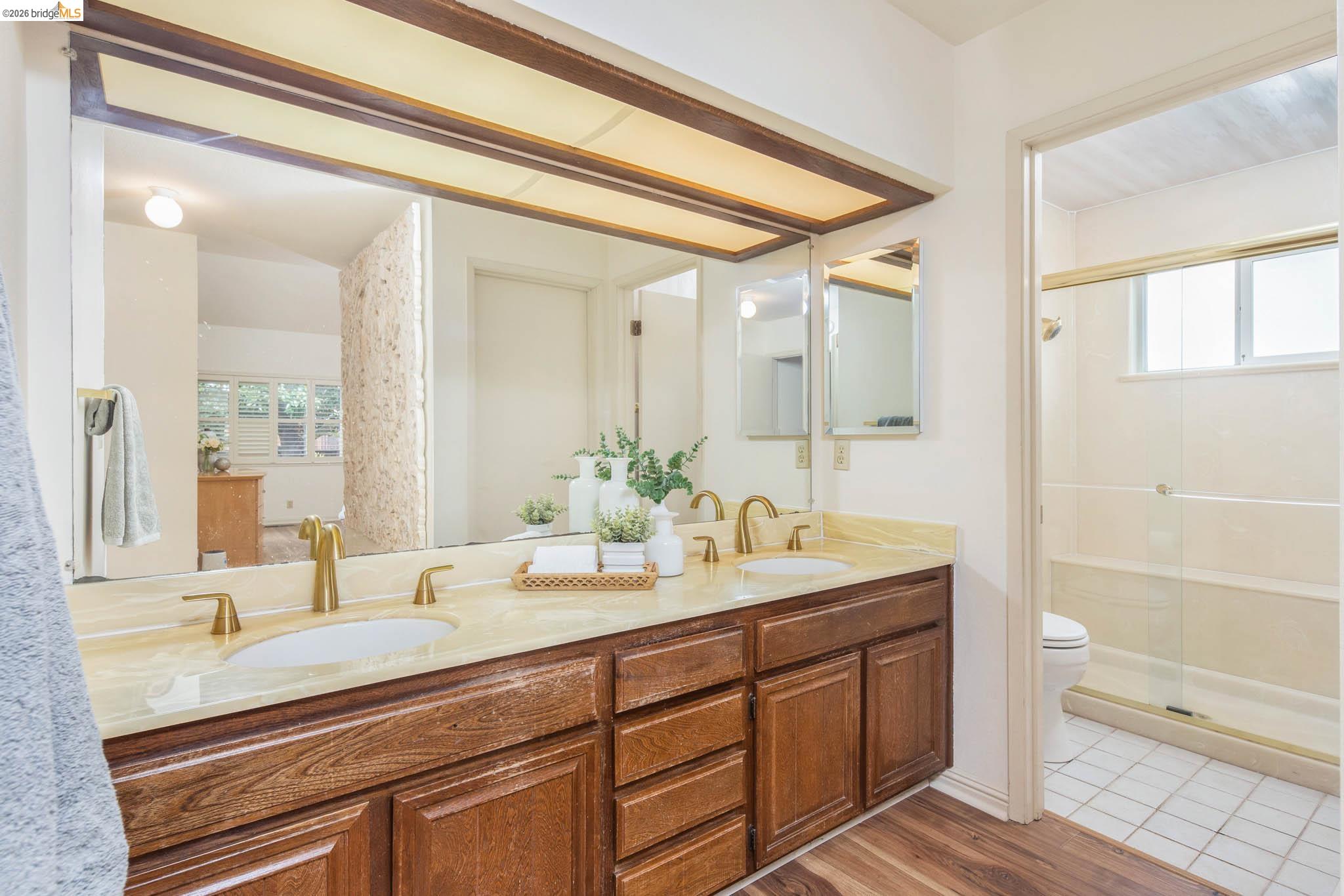 3237 Veracruz Drive San Ramon, CA 94583 - Photo 40 of 59 a spacious bathroom with a granite countertop sink mirror and a toilet