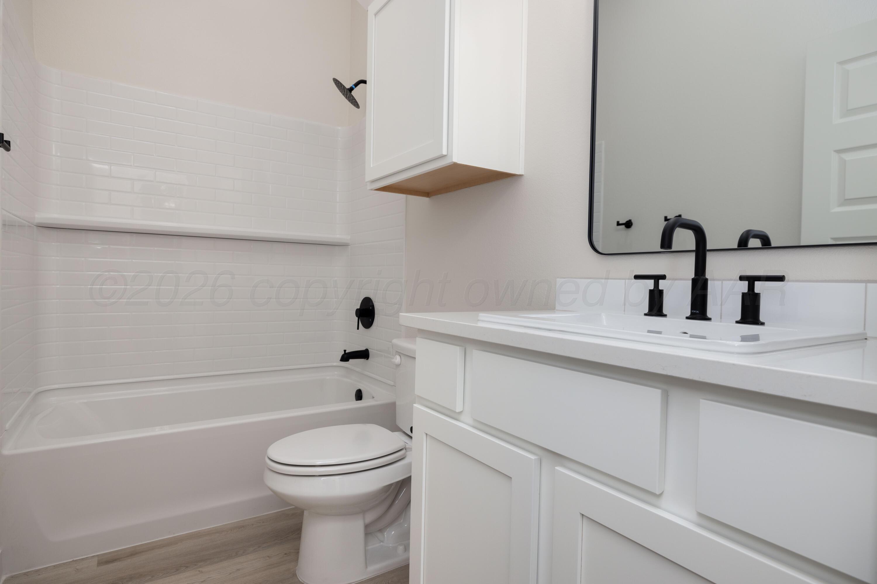 3005 Frontier Lane Amarillo, TX 79124 - Photo 12 of 15 a bathroom with a sink a toilet and a bathtub