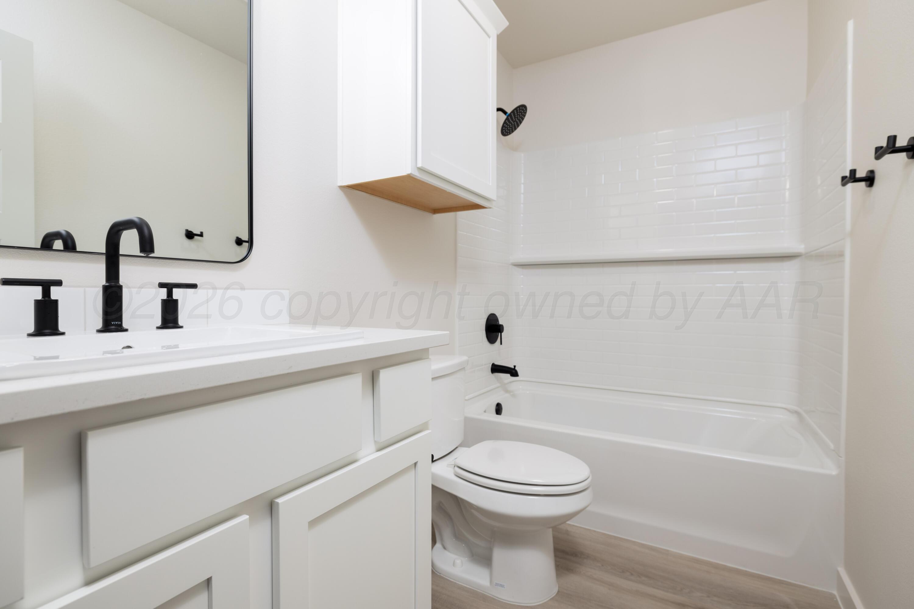 3005 Frontier Lane Amarillo, TX 79124 - Photo 13 of 15 a bathroom with a sink a toilet and a bathtub