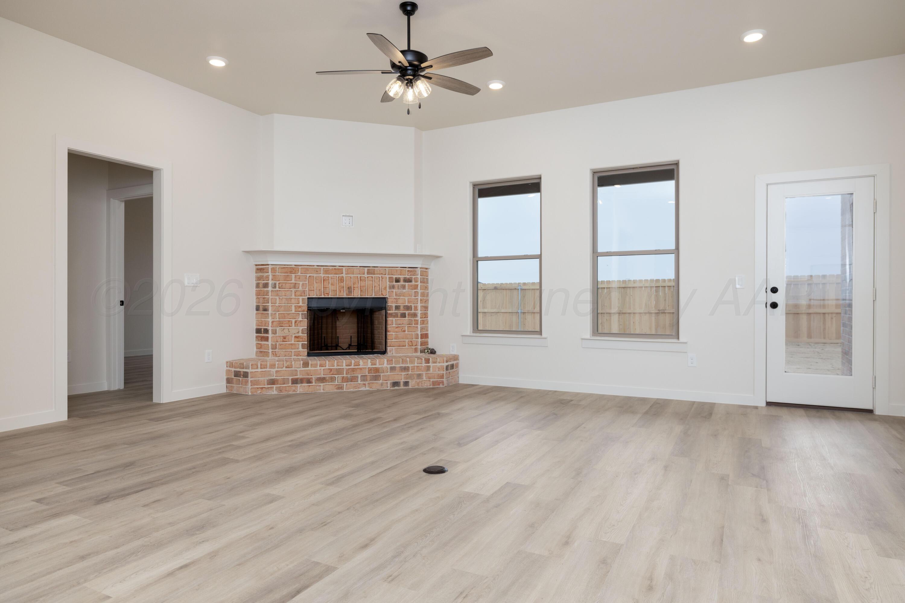 3005 Frontier Lane Amarillo, TX 79124 - Photo 3 of 15 a view of an empty room with a fireplace and a window