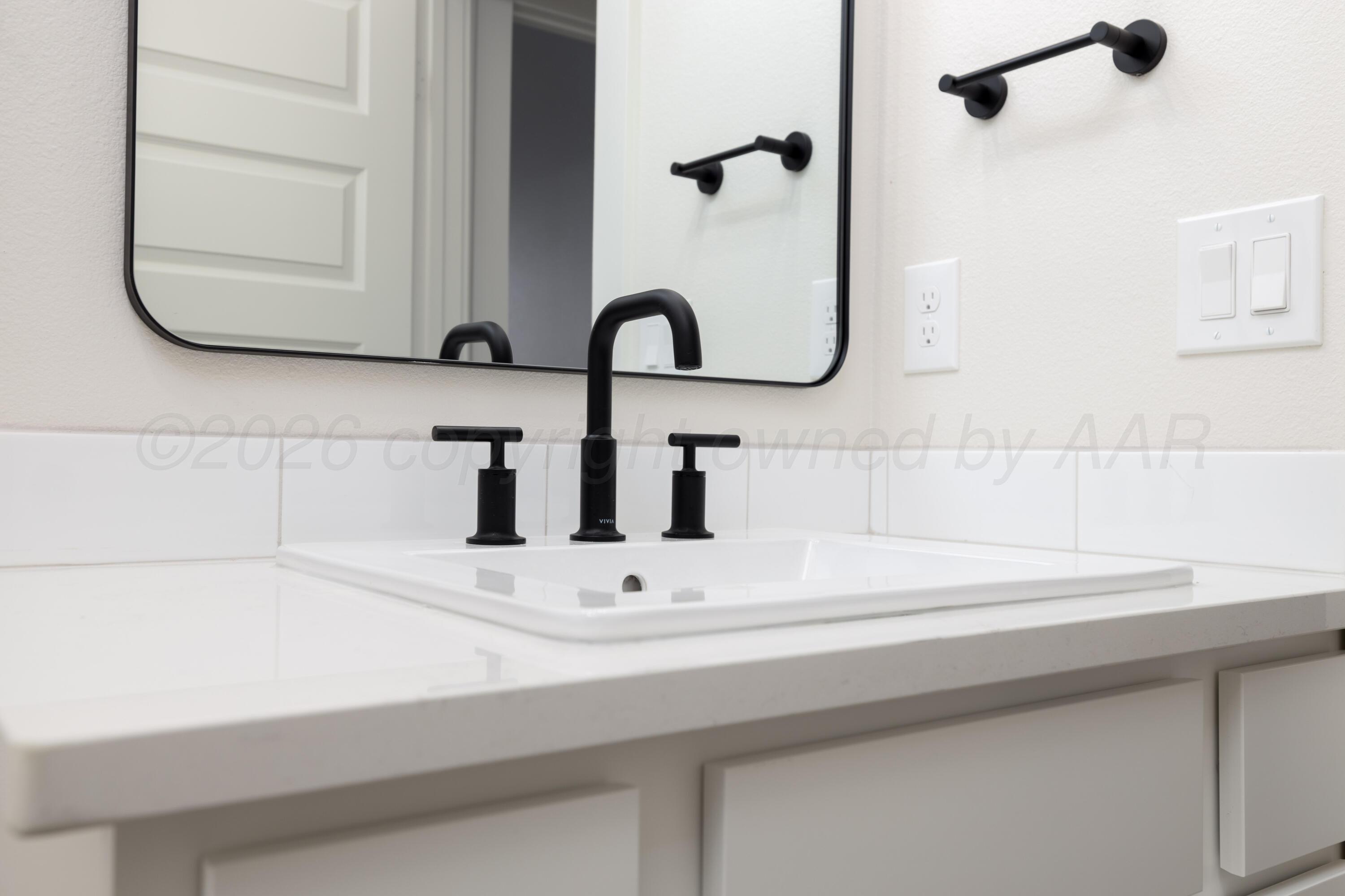 3005 Frontier Lane Amarillo, TX 79124 - Photo 8 of 15 a bathroom with a sink and a mirror