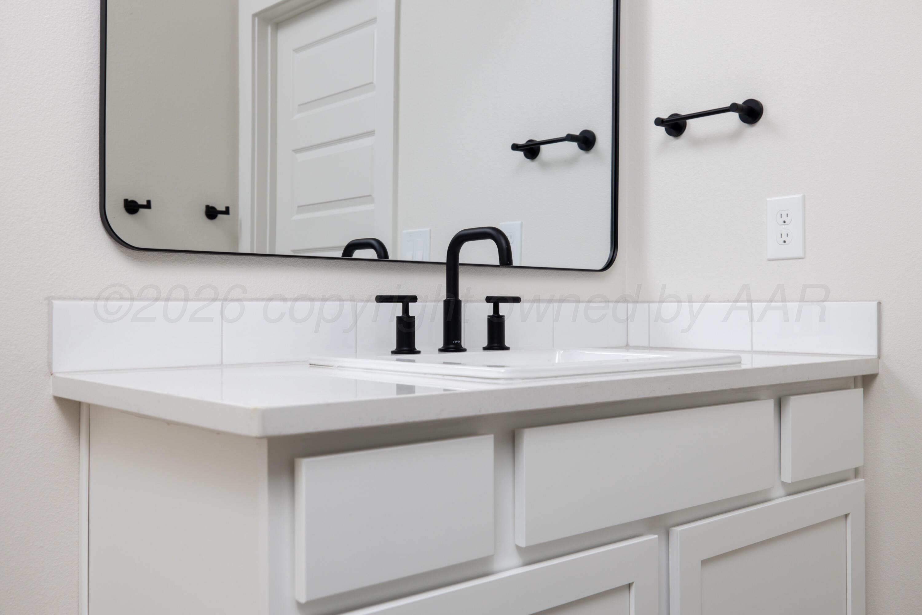 3005 Frontier Lane Amarillo, TX 79124 - Photo 10 of 15 a bathroom with a sink and a mirror