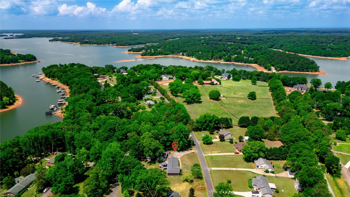 1815 Pearman Dairy Road Anderson, SC 29625 - Photo 33 of 35 An aerial perspective reveals a serene lakefront community with lush green trees and residential lots.