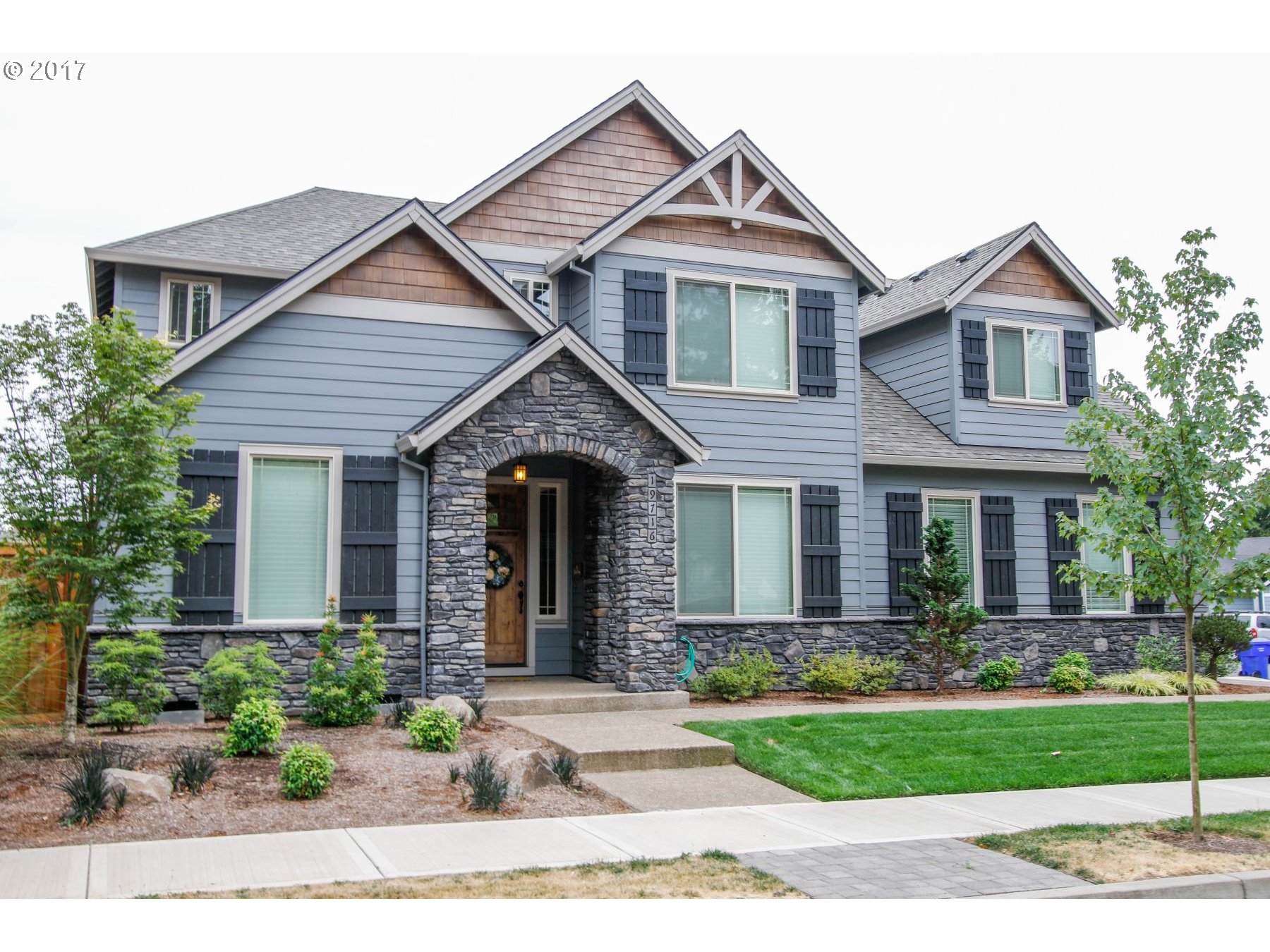 a front view of a house with garden