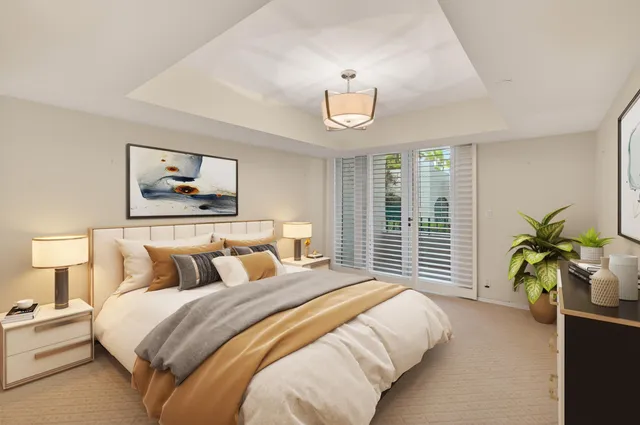 a bedroom with bed and a large window