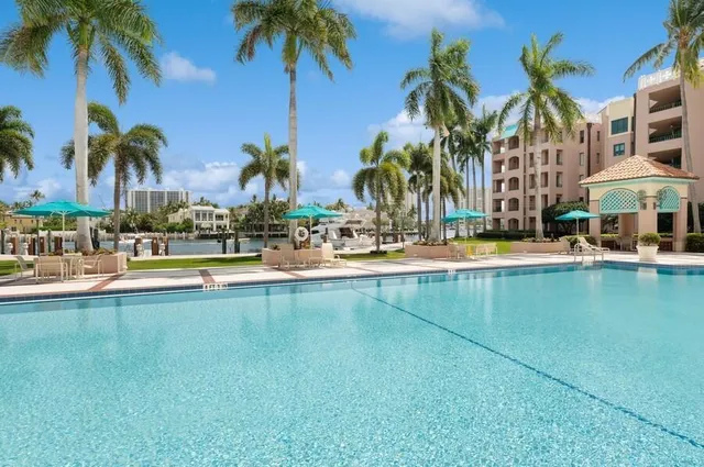 a view of swimming pool with palm trees
